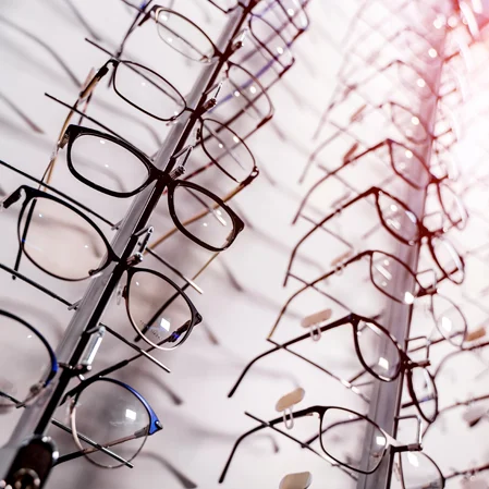 A wall rack displaying eyeglass frames