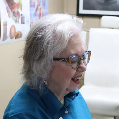 A headshot photo of Valerie DeWar, the front of office staff member